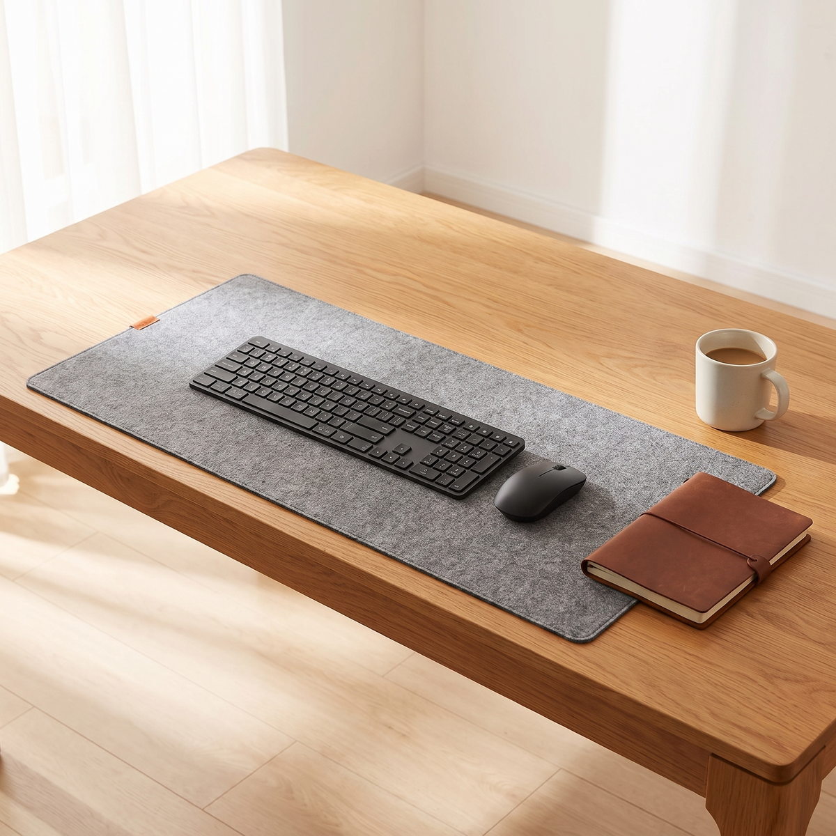 Top down view of a desk with the Thoren felt desk mat